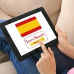 Online Spanish course women with a tablet in hand